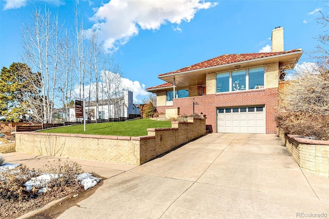 view of front of house with a garage and a front lawn