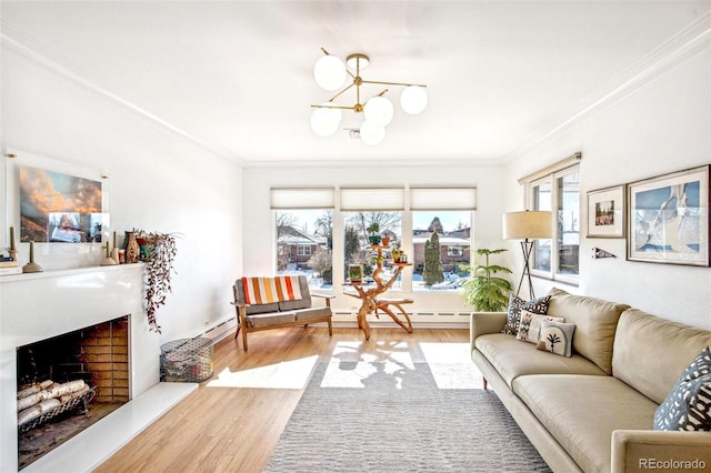 living room featuring a baseboard heating unit, crown molding, and light hardwood / wood-style flooring