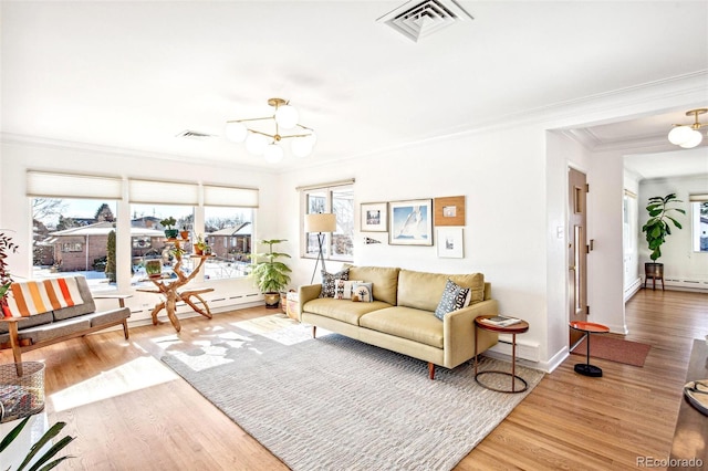 living room with crown molding, wood-type flooring, a baseboard heating unit, and plenty of natural light