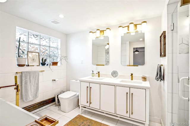 bathroom featuring toilet, an enclosed shower, vanity, ceiling fan, and tile patterned flooring