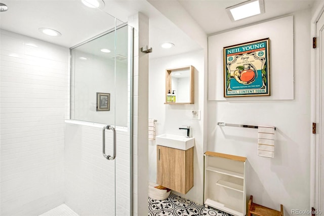 bathroom with vanity and a shower with shower door