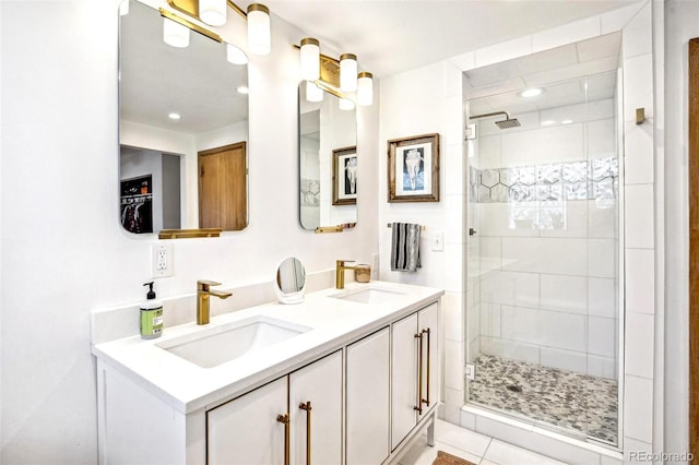 bathroom featuring a stall shower, a sink, and double vanity