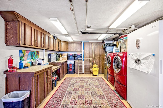 interior space featuring cabinet space, washing machine and dryer, and a textured ceiling