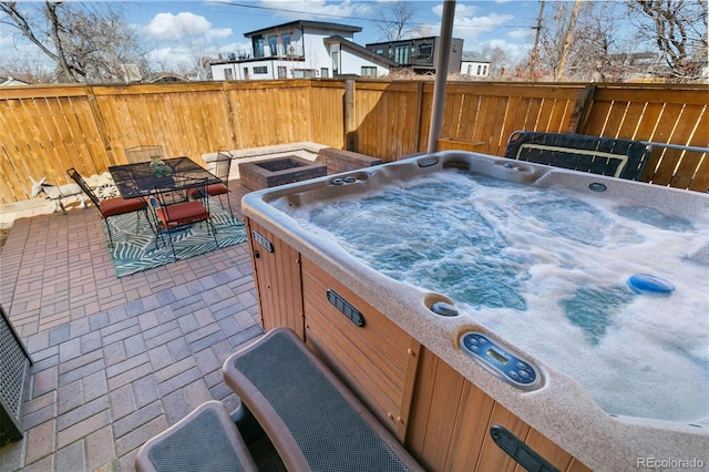 view of patio / terrace featuring a hot tub, fence, and outdoor dining space