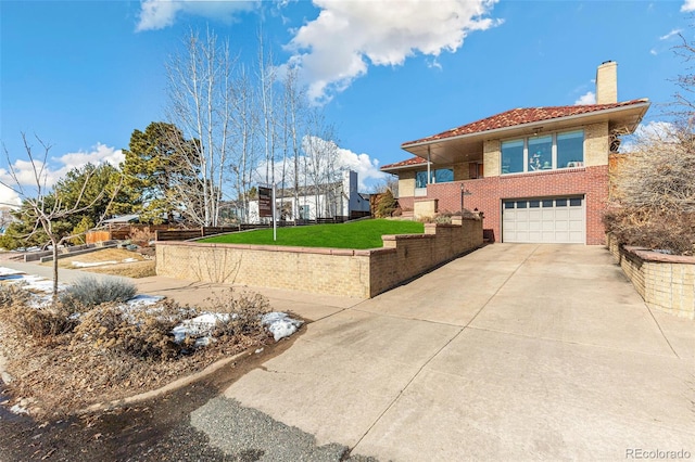 view of front of property featuring brick siding, a chimney, a garage, driveway, and a front lawn