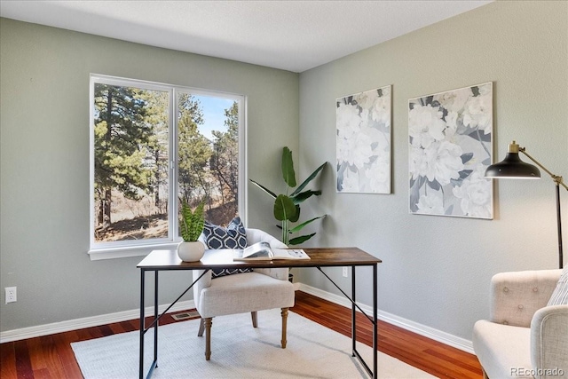 office featuring wood finished floors, visible vents, and baseboards