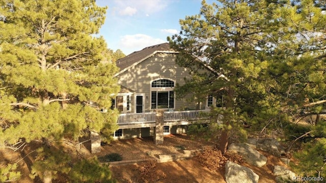 rear view of property with a wooden deck