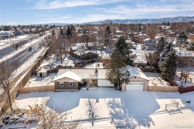 snowy aerial view with a mountain view