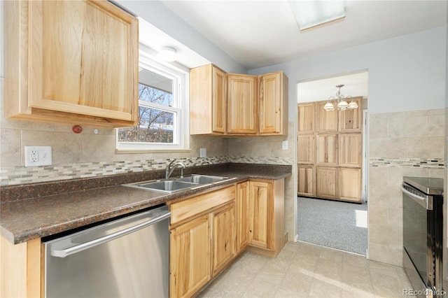 kitchen featuring sink, hanging light fixtures, stainless steel dishwasher, light brown cabinetry, and a chandelier