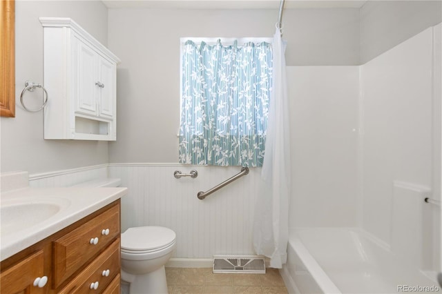 full bathroom featuring tile patterned flooring, vanity, toilet, and shower / tub combo