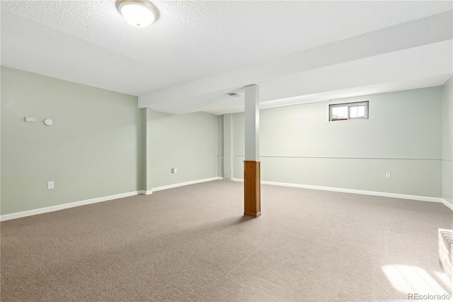 basement featuring carpet and a textured ceiling