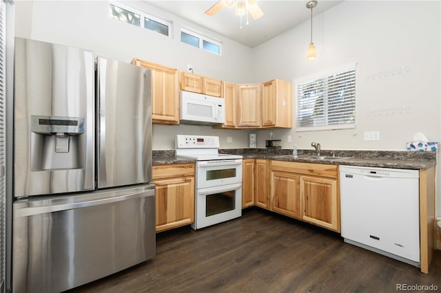 kitchen featuring white appliances, sink, decorative light fixtures, dark hardwood / wood-style floors, and plenty of natural light