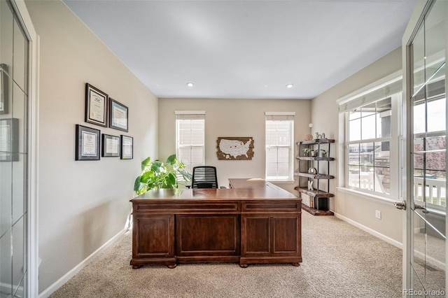 office space featuring baseboards, recessed lighting, and light carpet