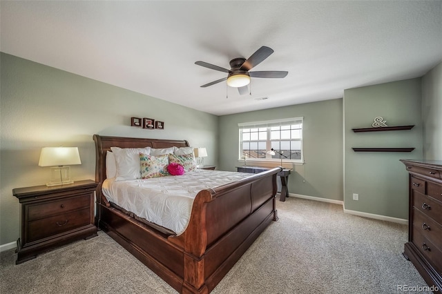 carpeted bedroom with baseboards, a ceiling fan, and visible vents
