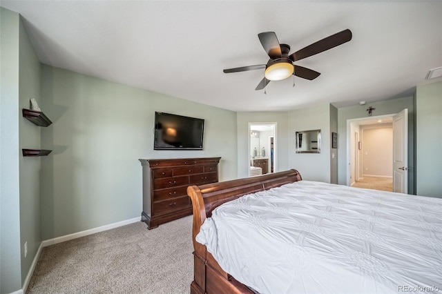 carpeted bedroom with baseboards, connected bathroom, ceiling fan, and visible vents