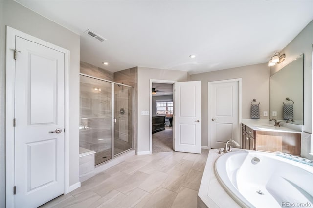 bathroom with visible vents, vanity, a bath, a shower stall, and a ceiling fan