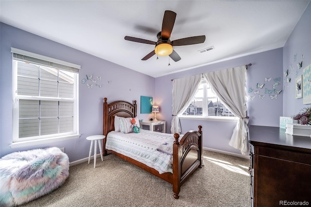 carpeted bedroom featuring visible vents, baseboards, and ceiling fan