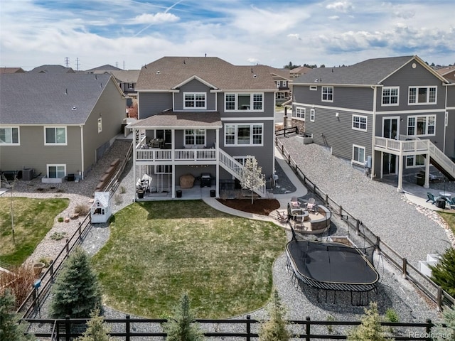 back of property with stairs and a fenced backyard