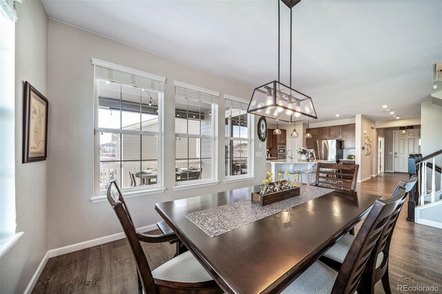 23879 E Narrowleaf Pl, Aurora, CO 80016 - dining room with dark wood-style floors, recessed lighting, and stairway