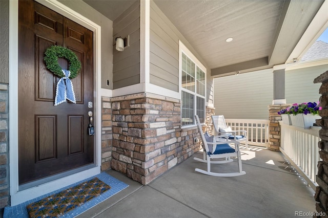 23879 E Narrowleaf Pl, Aurora, CO 80016 - doorway to property featuring covered porch and stone siding