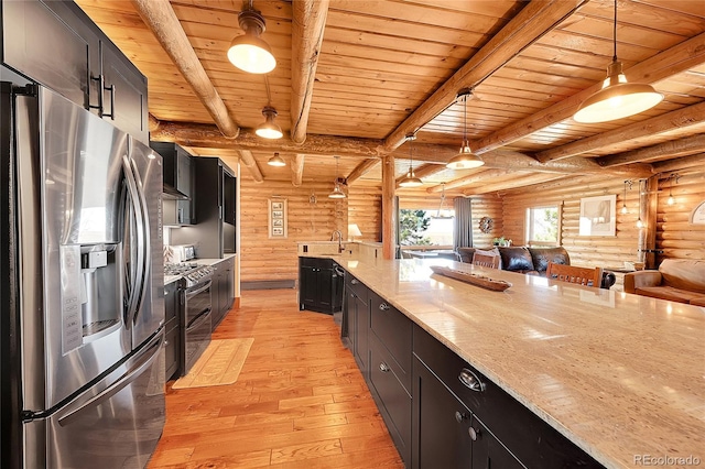 kitchen featuring light stone counters, light hardwood / wood-style flooring, appliances with stainless steel finishes, pendant lighting, and beam ceiling