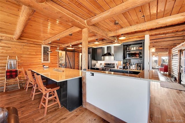 kitchen with pendant lighting, wood-type flooring, stainless steel range oven, wooden ceiling, and wall chimney exhaust hood