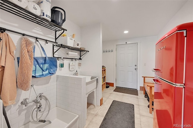 bathroom featuring a washtub and tile patterned floors