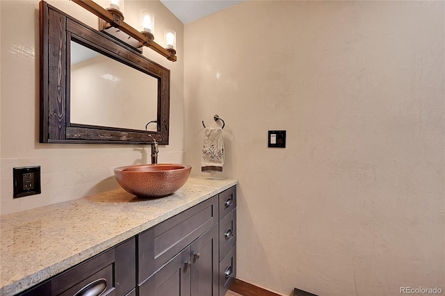 bathroom featuring vanity and backsplash