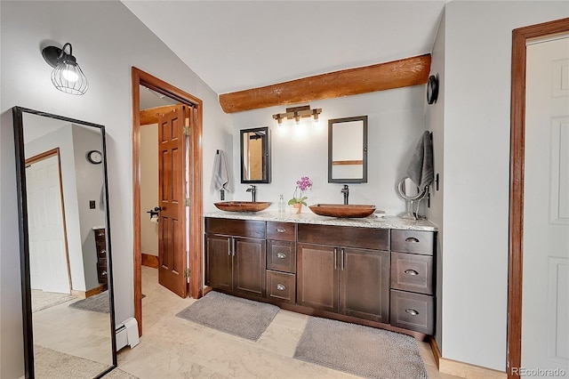 bathroom featuring lofted ceiling, vanity, and a baseboard heating unit