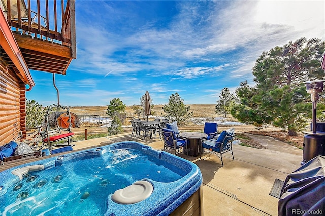 view of pool with a hot tub and a patio