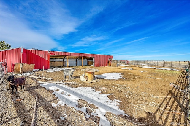 yard covered in snow with an outdoor structure