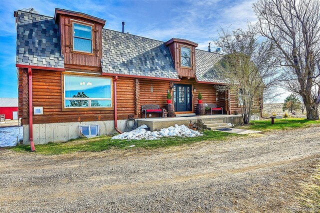 48155 E 56th Ave, Bennett, CO 80102 - log-style house featuring a shingled roof and log exterior