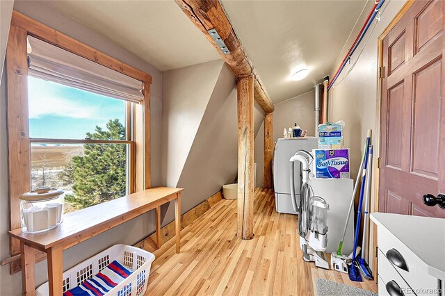 48155 E 56th Ave, Bennett, CO 80102 - washroom with separate washer and dryer, light wood-style flooring, and baseboards