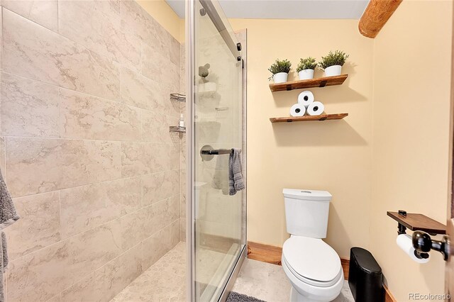 48155 E 56th Ave, Bennett, CO 80102 - bathroom with toilet, a stall shower, and baseboards