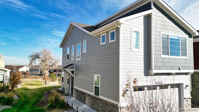 view of home's exterior featuring stone siding and an attached garage