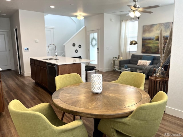 dining area featuring baseboards, dark wood-style flooring, and ceiling fan