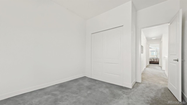 unfurnished bedroom with baseboards and carpet flooring