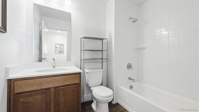 bathroom featuring vanity, toilet, shower / tub combination, and wood finished floors