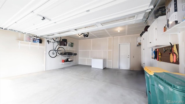 garage featuring a garage door opener and refrigerator