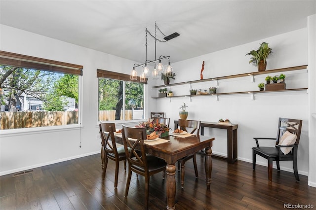 dining room with visible vents, baseboards, and dark wood-style floors