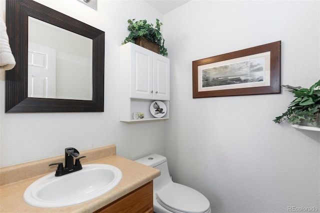half bathroom featuring toilet and vanity