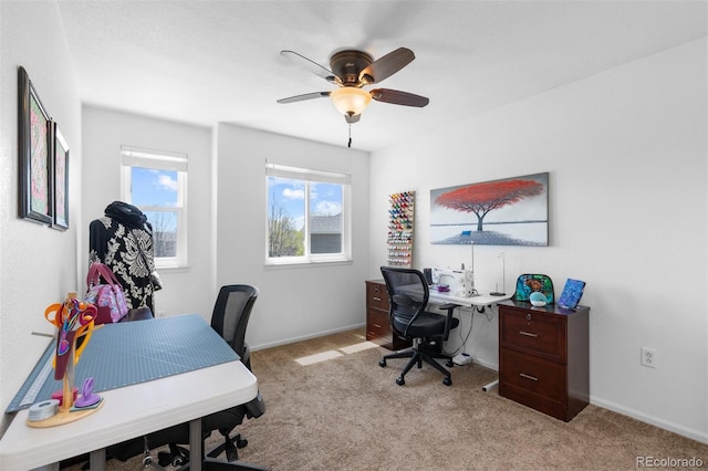 office with baseboards, light carpet, and a ceiling fan