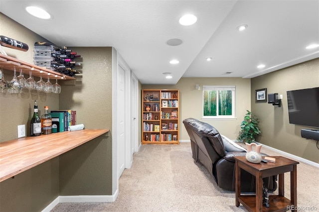 interior space featuring recessed lighting, a dry bar, baseboards, and light carpet