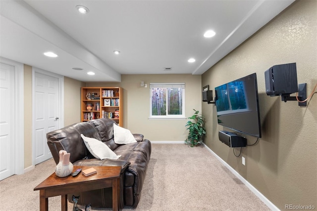 carpeted living area with recessed lighting and baseboards