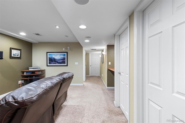 hallway with recessed lighting, baseboards, visible vents, and light colored carpet