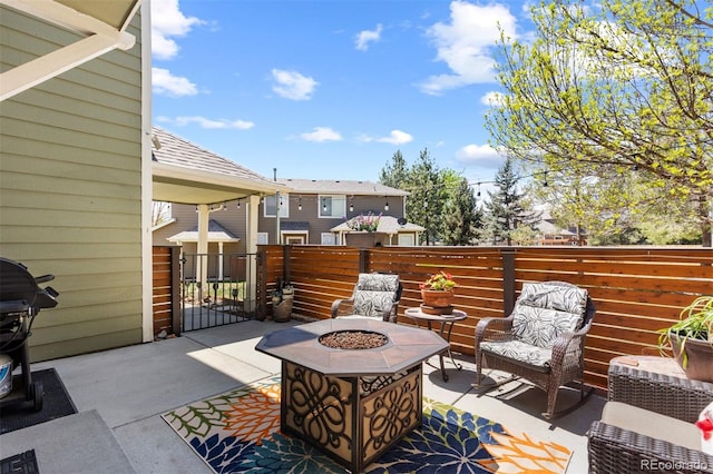 view of patio / terrace with fence and an outdoor fire pit