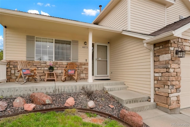 4873 Eckert St, Castle Rock, CO 80104 - entrance to property with stone siding, covered porch, and a garage