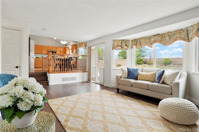 4873 Eckert St, Castle Rock, CO 80104 - living area featuring lofted ceiling, dark wood-style floors, and baseboards