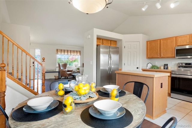 4873 Eckert St, Castle Rock, CO 80104 - dining area featuring stairway, lofted ceiling, light tile patterned floors, and track lighting