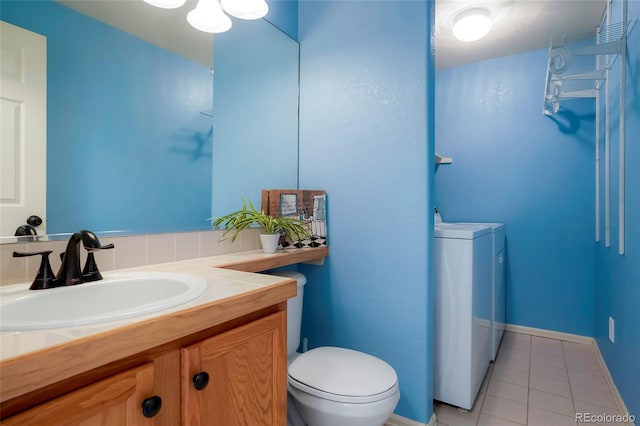 4873 Eckert St, Castle Rock, CO 80104 - bathroom with toilet, tile patterned floors, vanity, and washer and clothes dryer